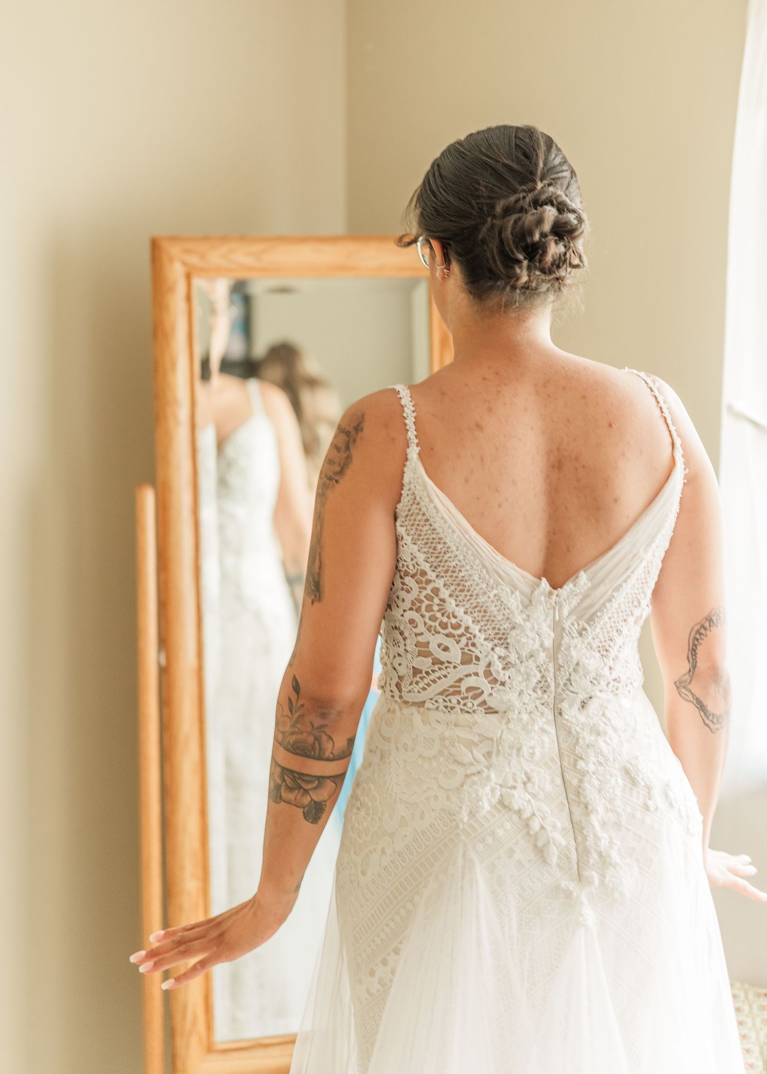 Back details of lace wedding dress with intricate beading and embellishments.