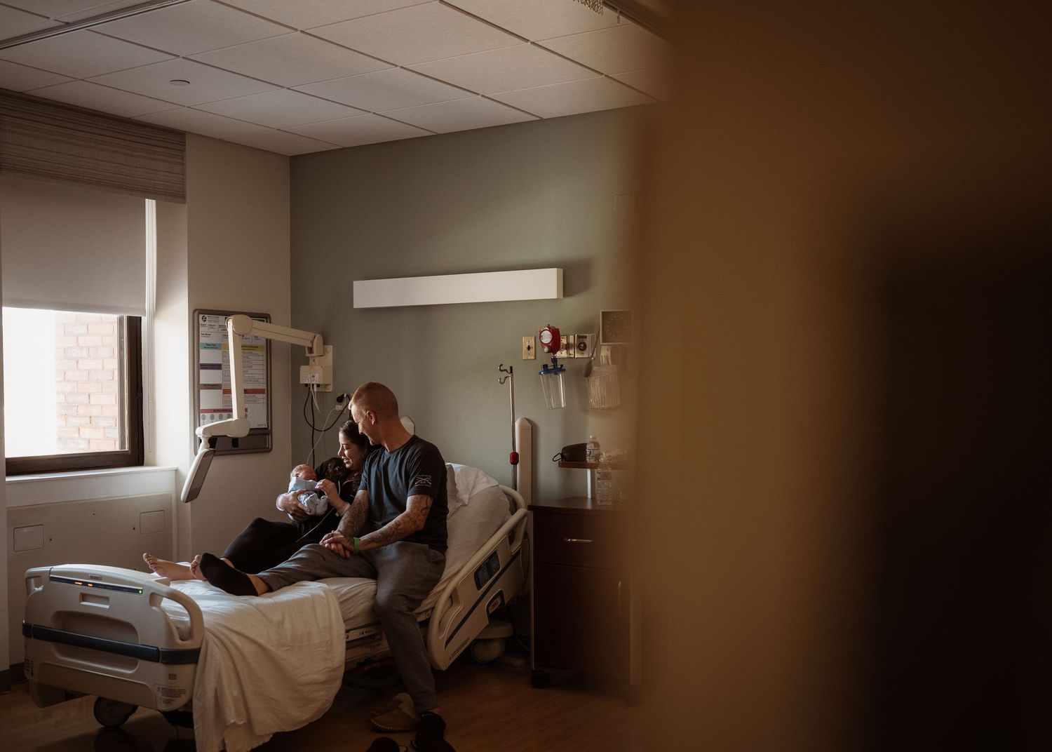 Hospital room scene showing patient care in natural lighting.