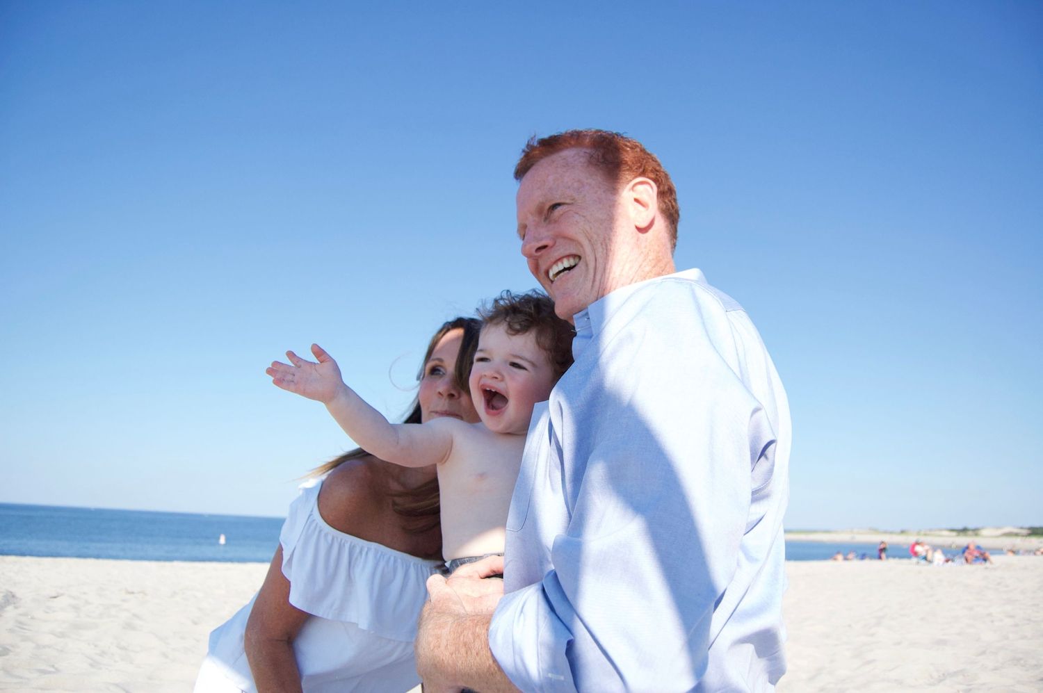 Joyful moment shared between parent and child at the beach.