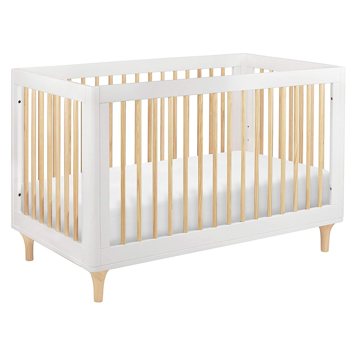 Modern white convertible crib with natural wood slats and contemporary legs for nursery decor.