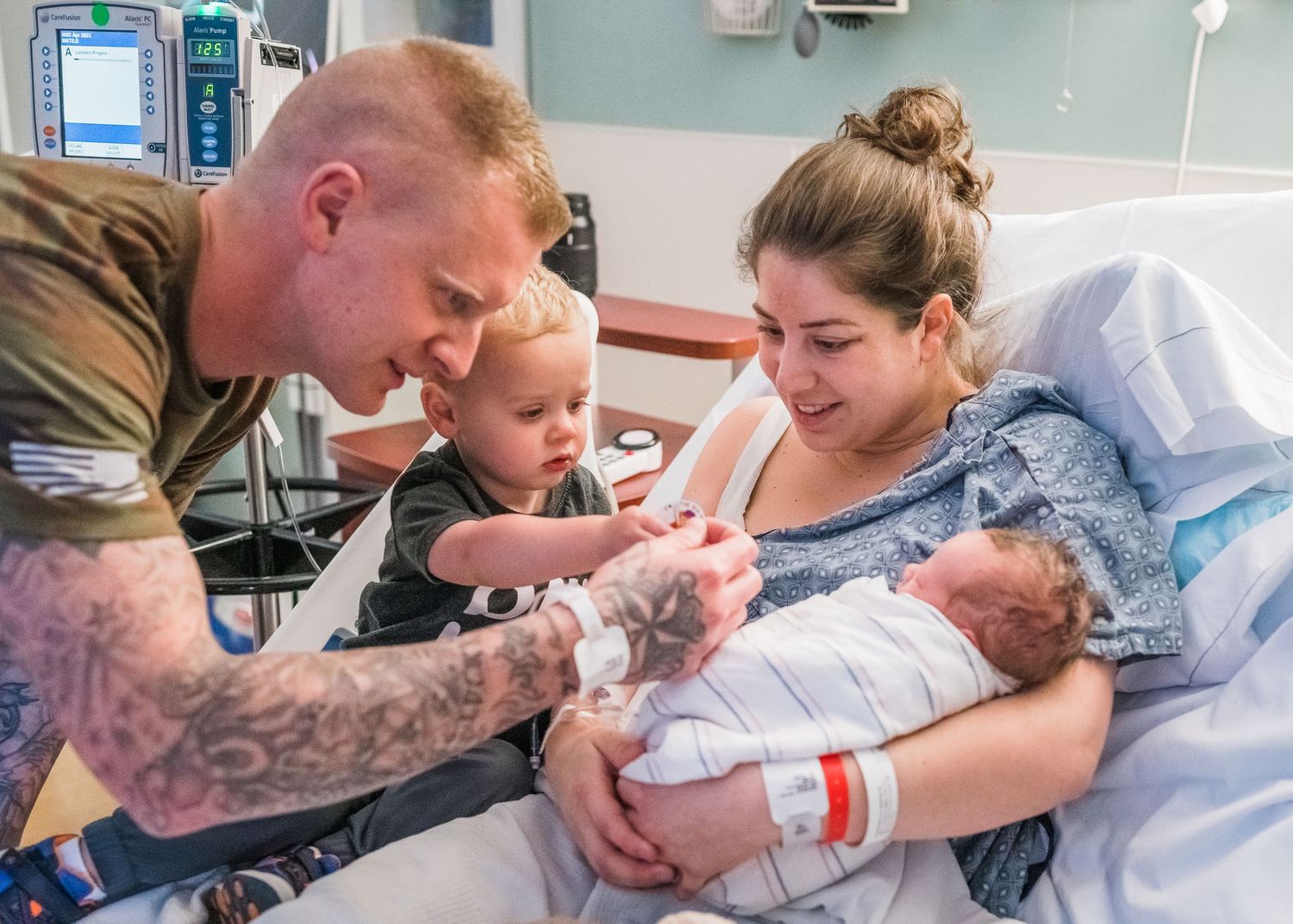 A heartwarming moment in a hospital room as a family meets their newborn baby for the first time.