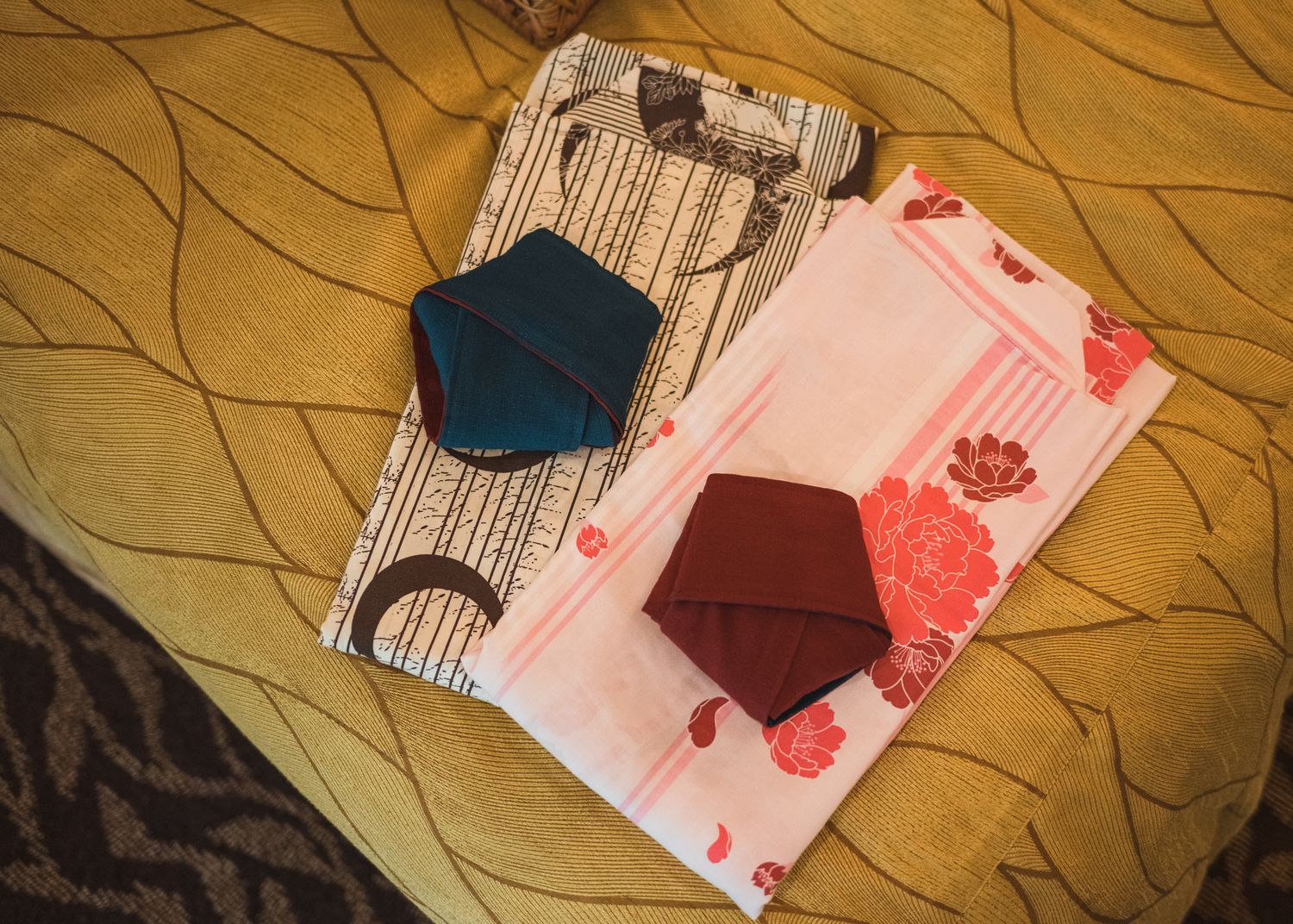 Collection of traditional Japanese papers or documents on textured fabric background.