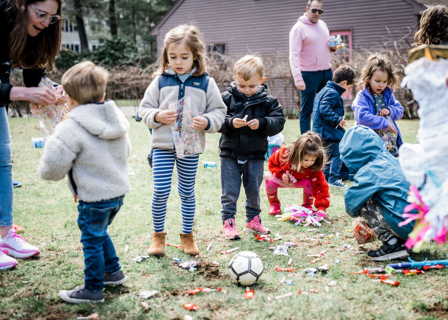 Kids picking up candy from a piñata