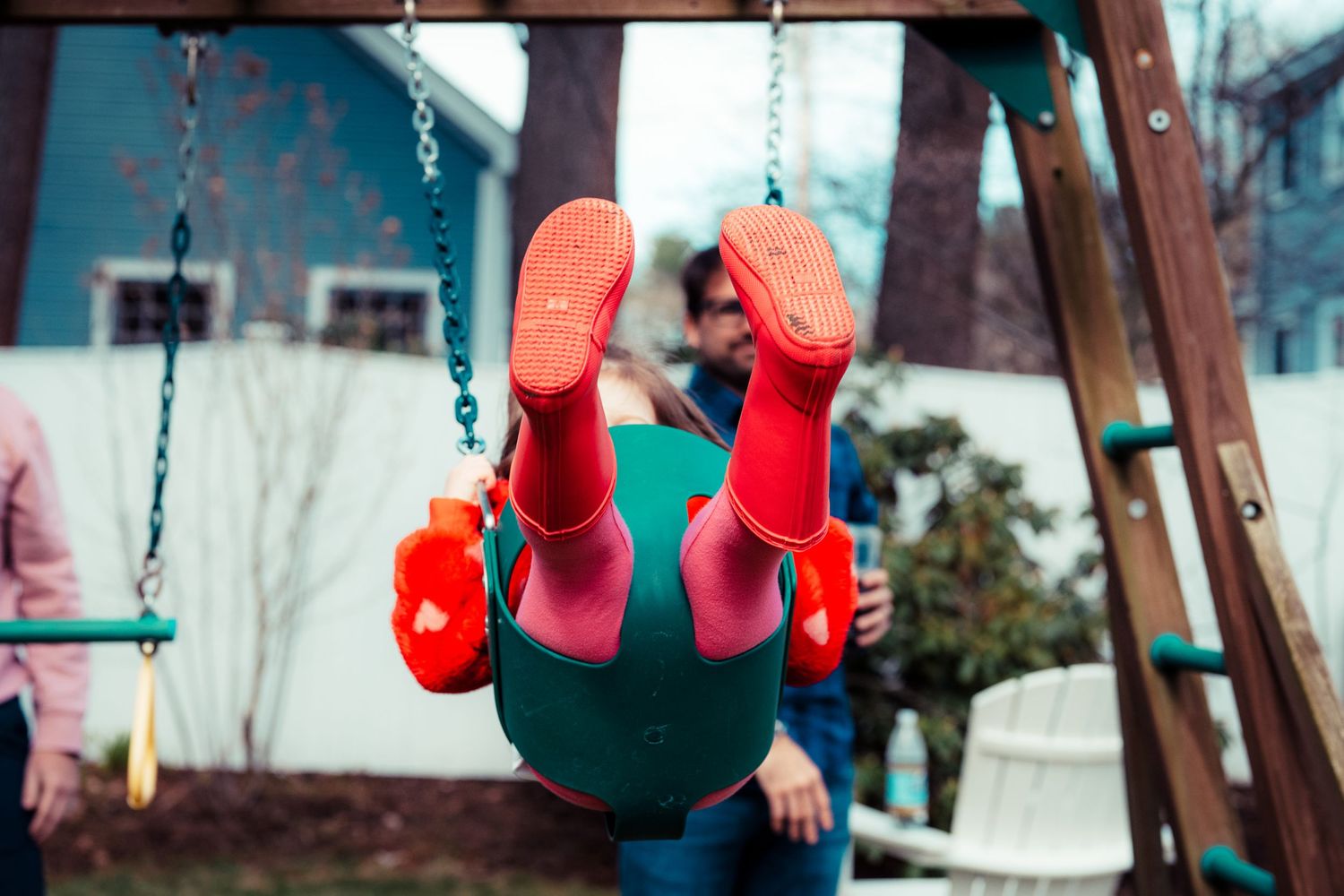 Girl in red boots on a swing