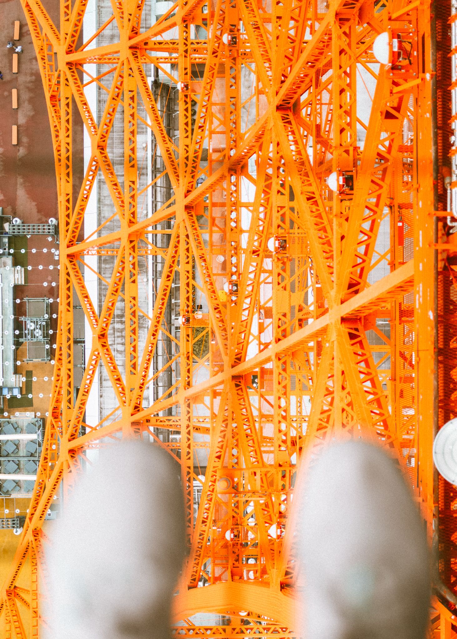 Close-up of Tokyo Tower's orange steel lattice structure illuminated at night.