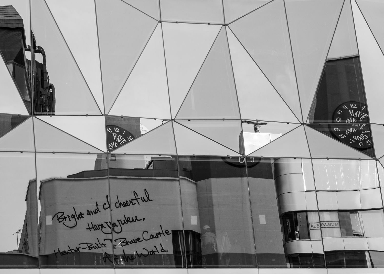 Modern geometric architecture with angular lines and reflective surfaces in black and white.