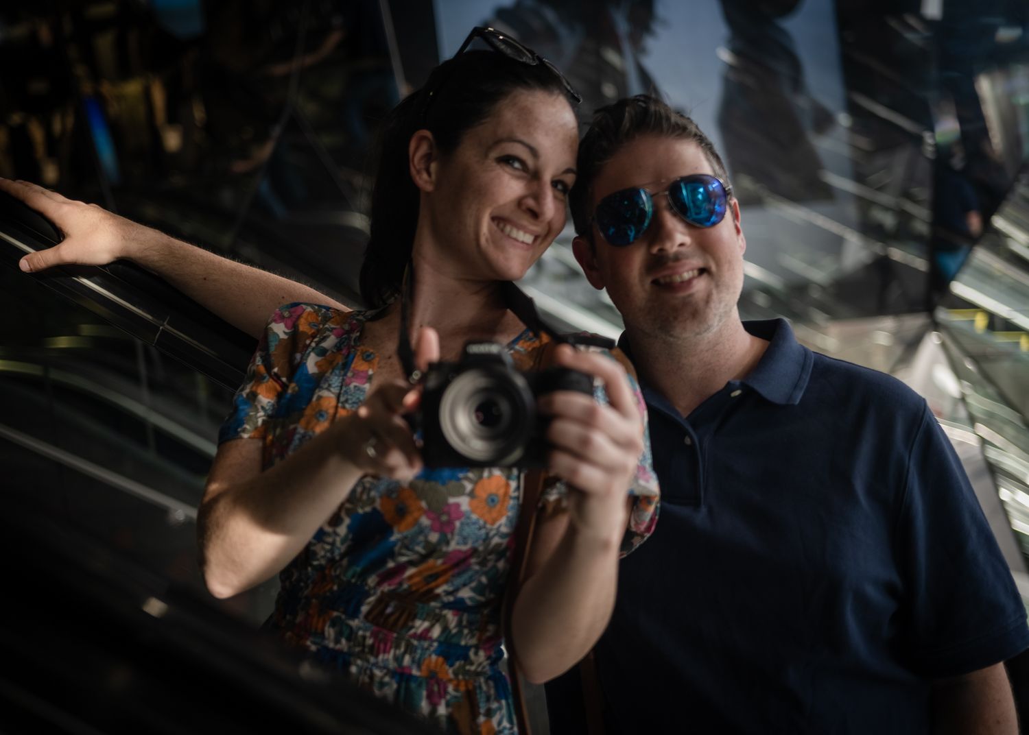 Two photographers with a camera enjoy taking pictures in an urban setting.