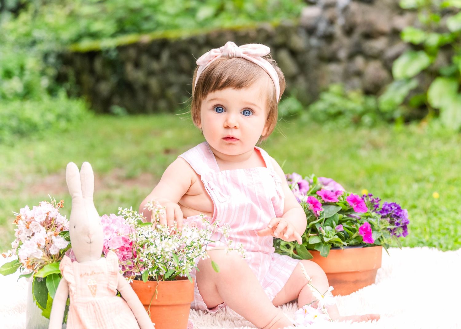 Garden scene with potted flowers and a decorative bunny.