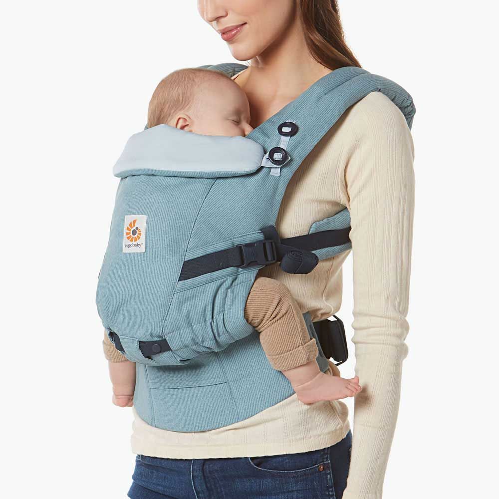 Ergonomic light blue baby carrier with adjustable straps and padded support for comfortable infant wearing.