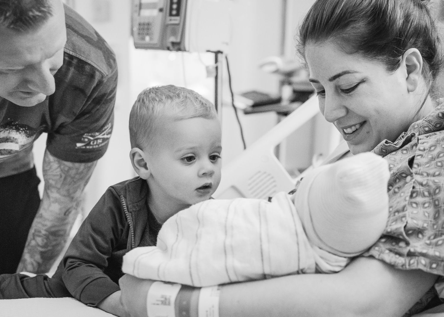 Family gathered around hospital bed sharing a tender moment together.