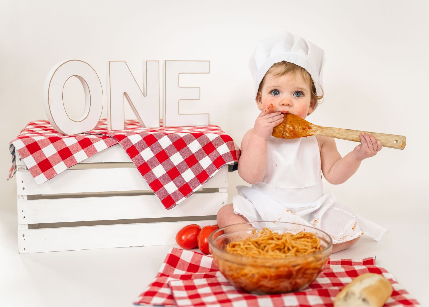 Spaghetti Smash first birthday. A small child in a chef's hat helps prepare spaghetti and meatballs in a series of cooking photos.