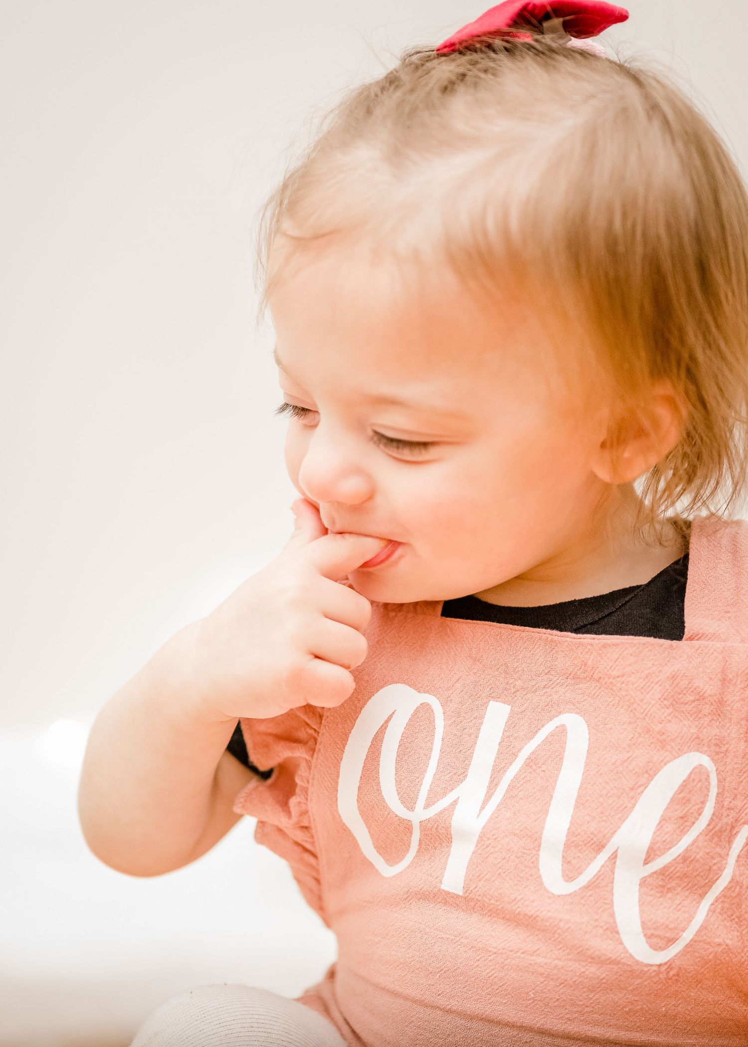 Candid moment of joyful laughter while wearing a pink celebration bib.