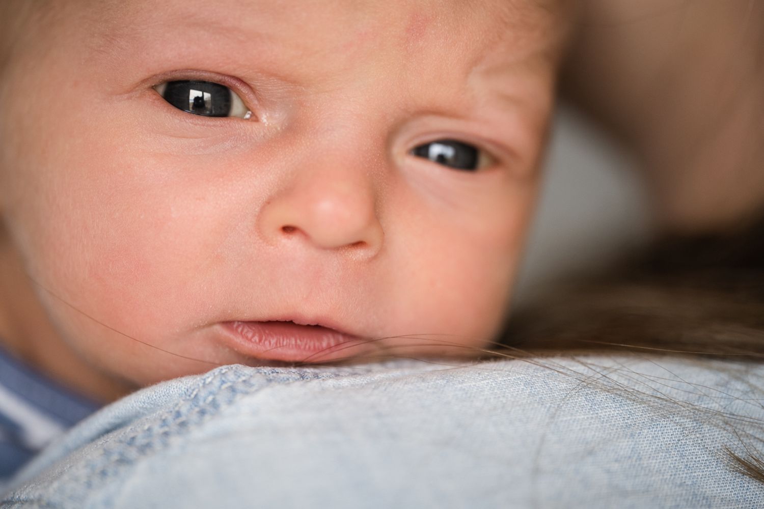 Extreme closeup of alert baby's face and eyes.