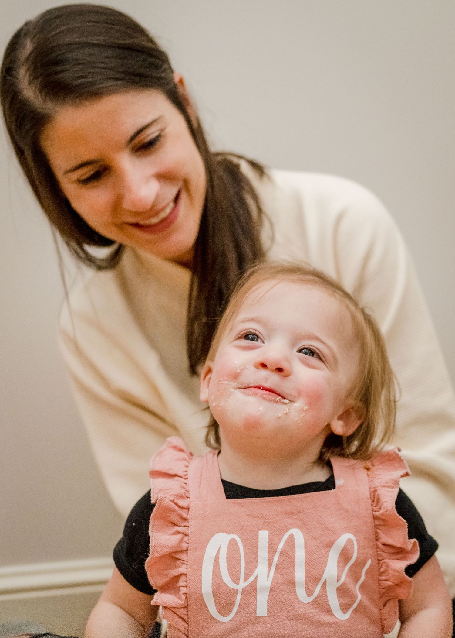 A sweet moment captured during a first birthday celebration with cake on face.