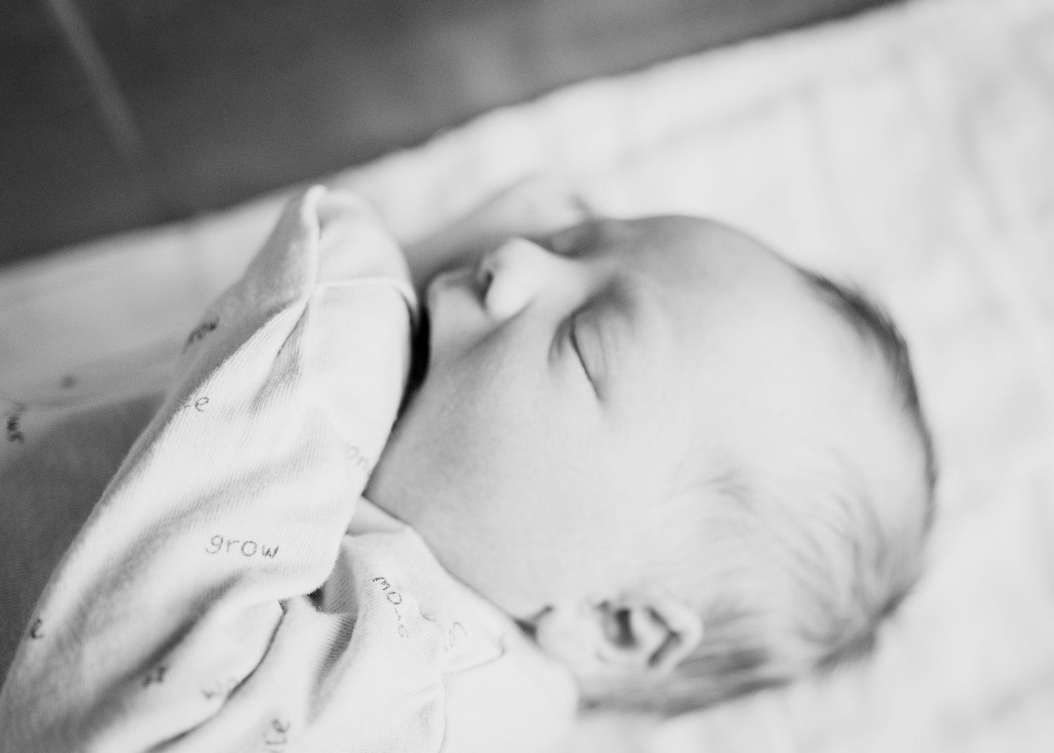 Close up black and white portrait of a sleeping newborn baby.