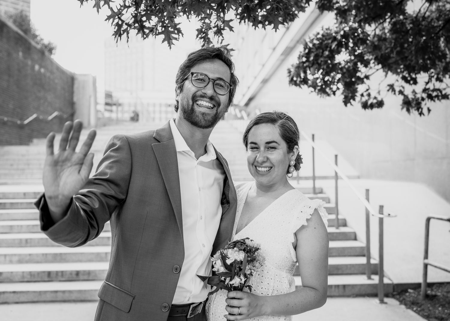 A couple shares a joyful moment together on outdoor steps.