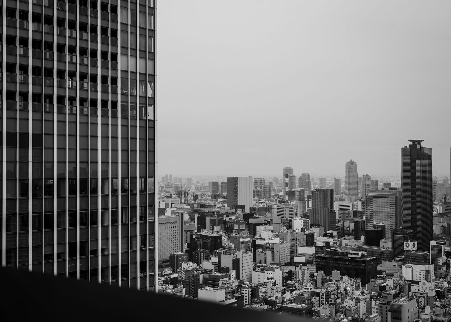 Black and white cityscape of Tokyo showing modern skyscrapers and urban architecture.
