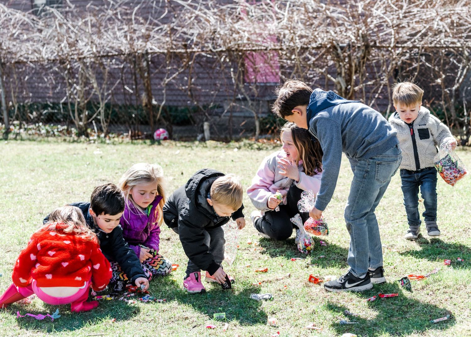 Kids picking up candy from a broken piñata