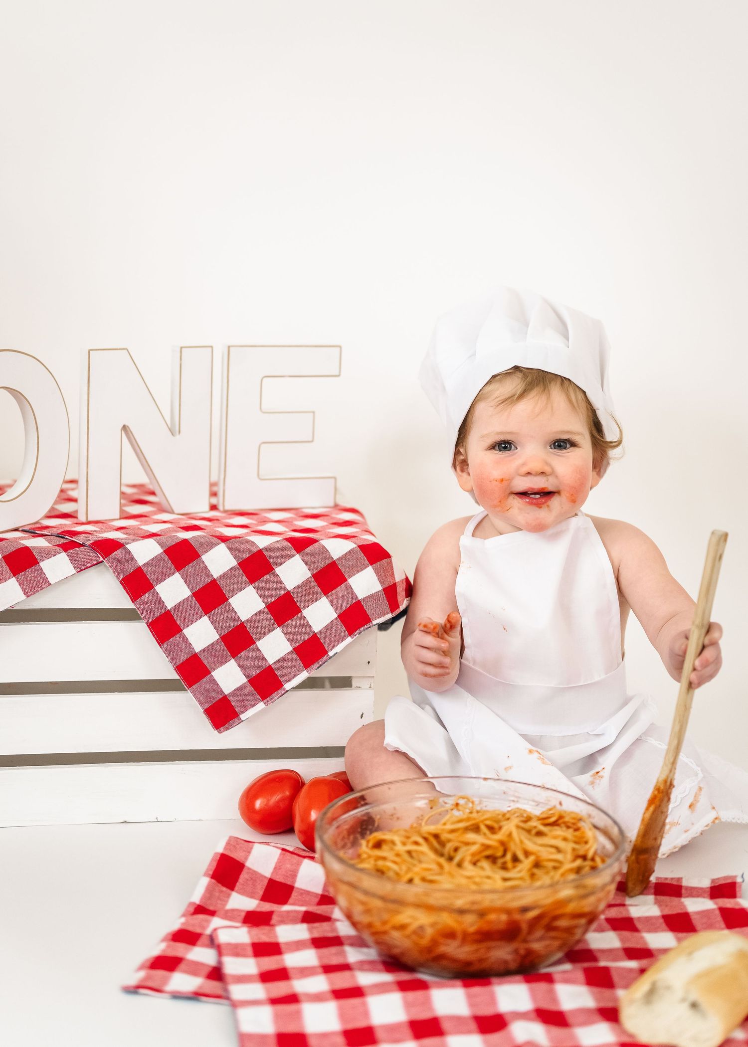 Spaghetti Smash birthday. A collage of cooking scenes with red checkered napkins, pasta dishes, and white bowls against a light background.