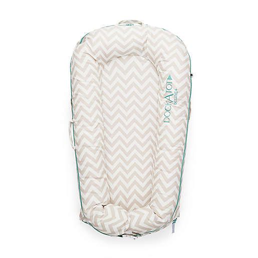 Portable baby lounger with chevron pattern fabric and teal trim for infant comfort.