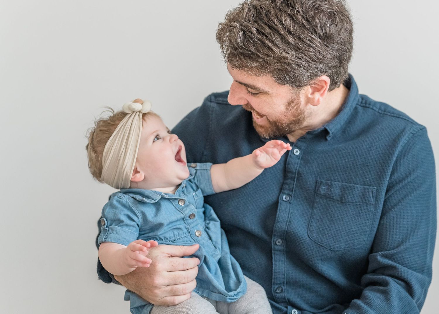 A parent and child share tender moments together against a light gray background in a collage of three photos.