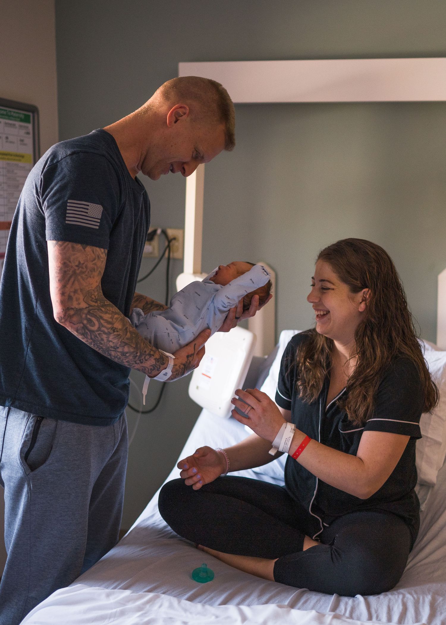 A joyful moment in the hospital as parents bond with their newborn baby.