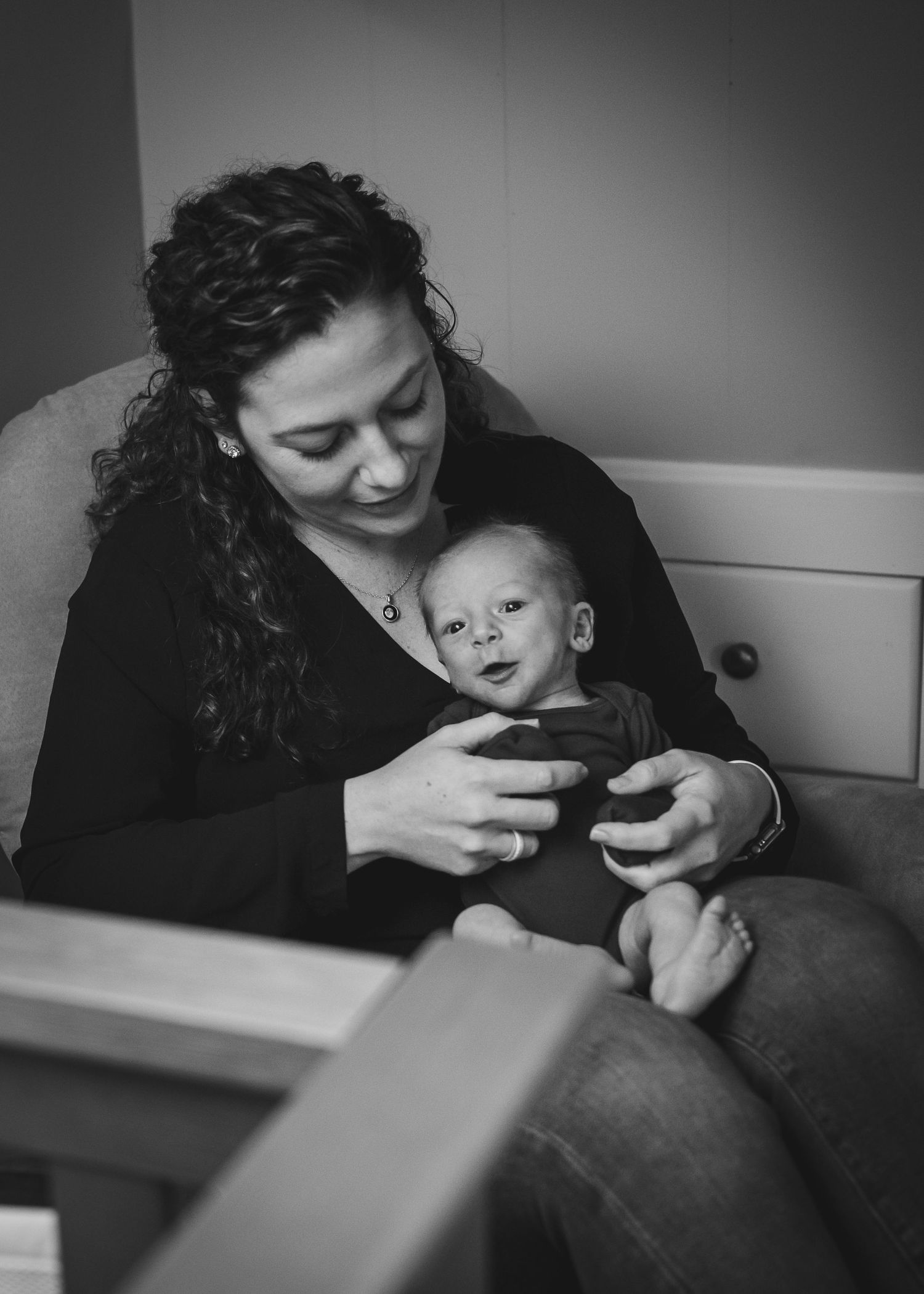 Mother and baby sharing quiet moment in rocking chair.