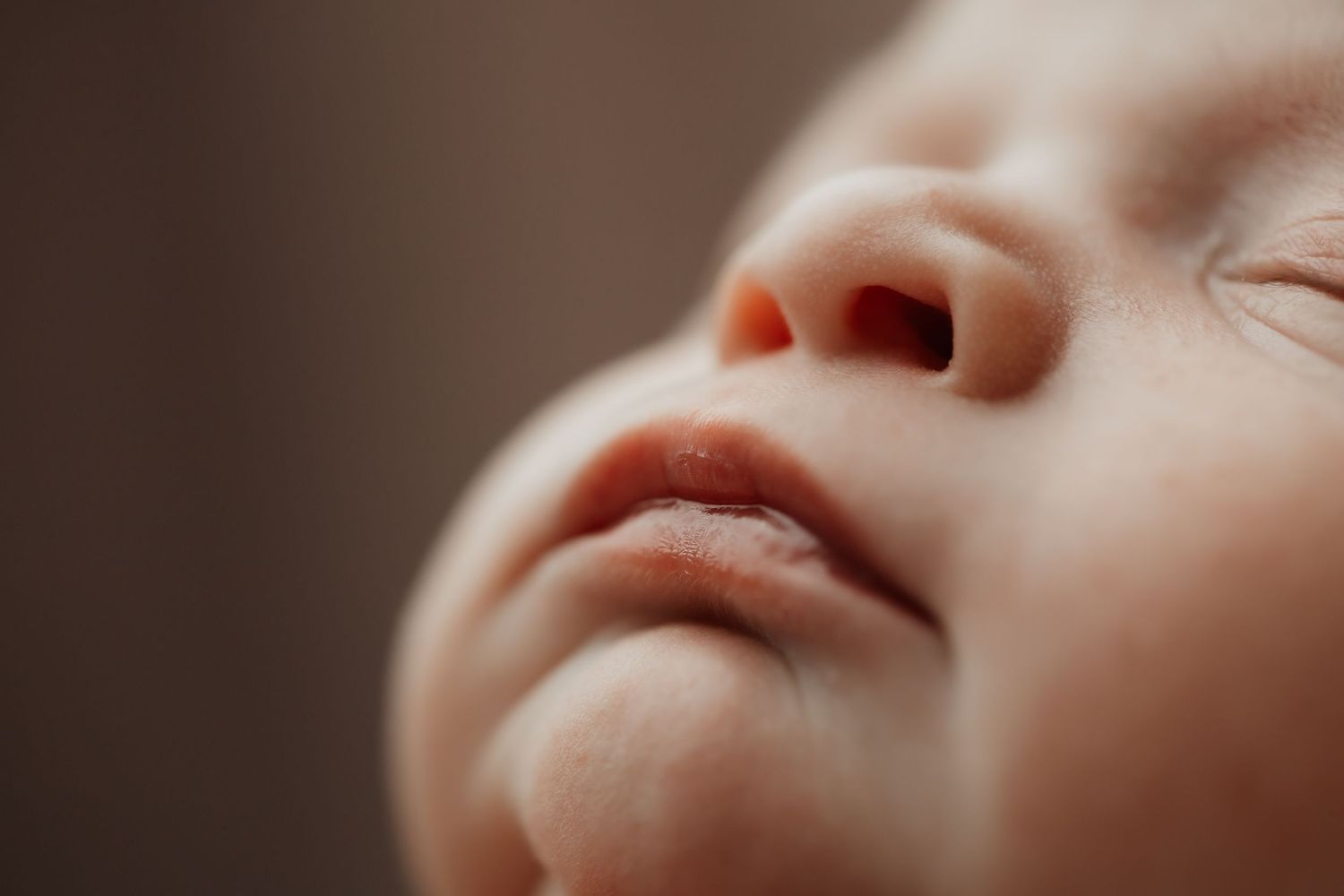 Extreme close-up of a peaceful sleeping newborn baby's nose and lips.