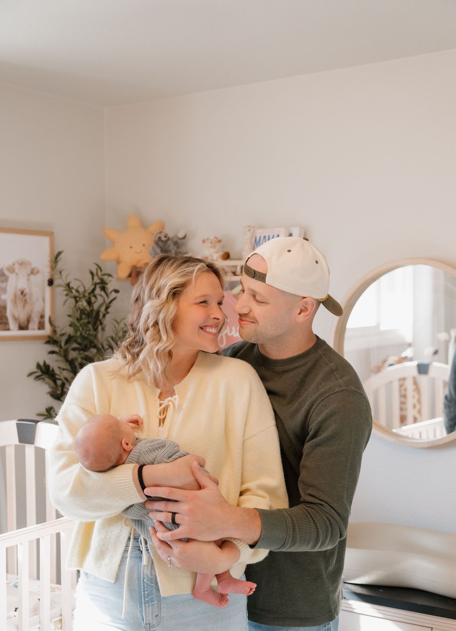 A happy couple embracing and smiling in a cozy home setting.