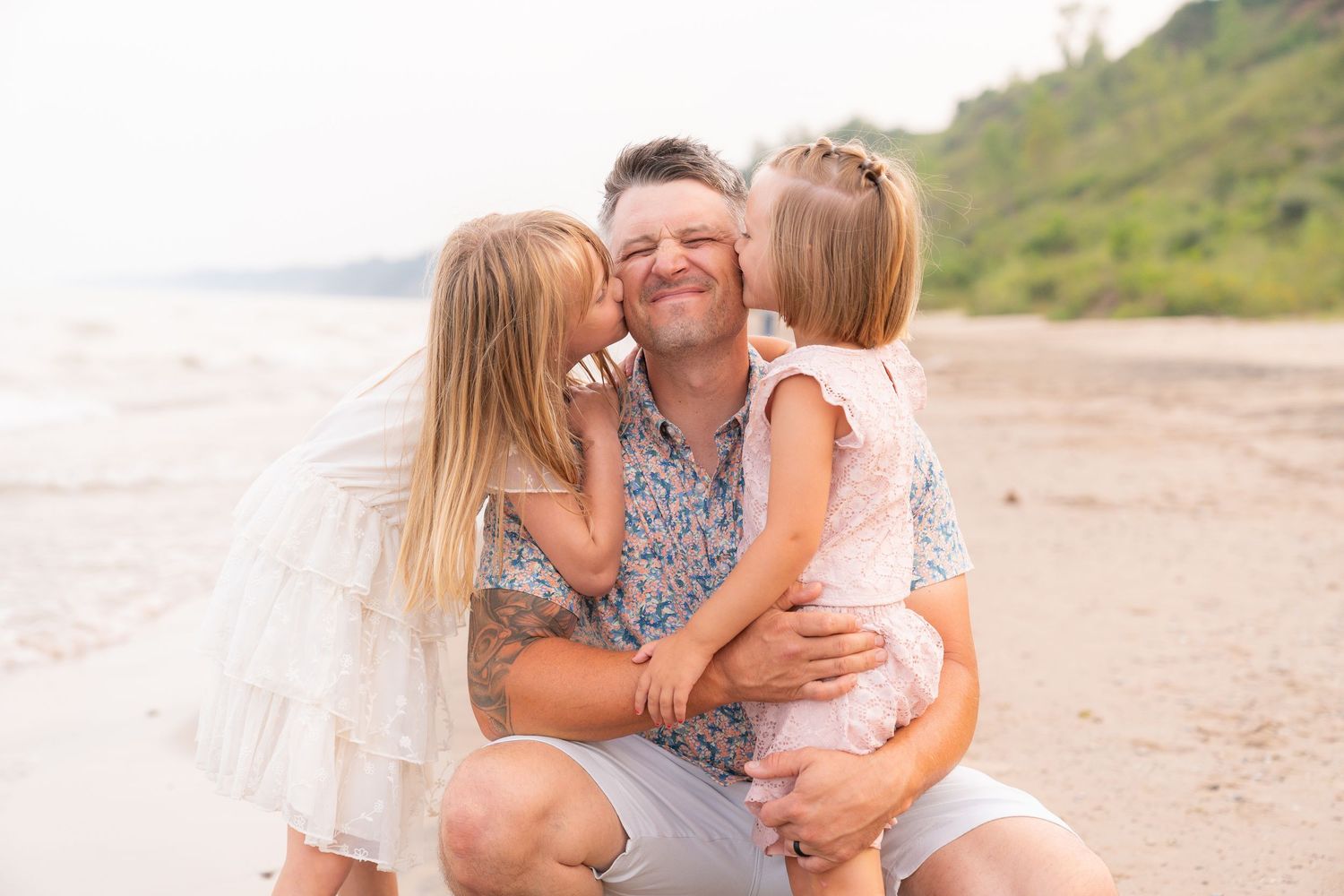 A family of three enjoying a sunny day at the beach.