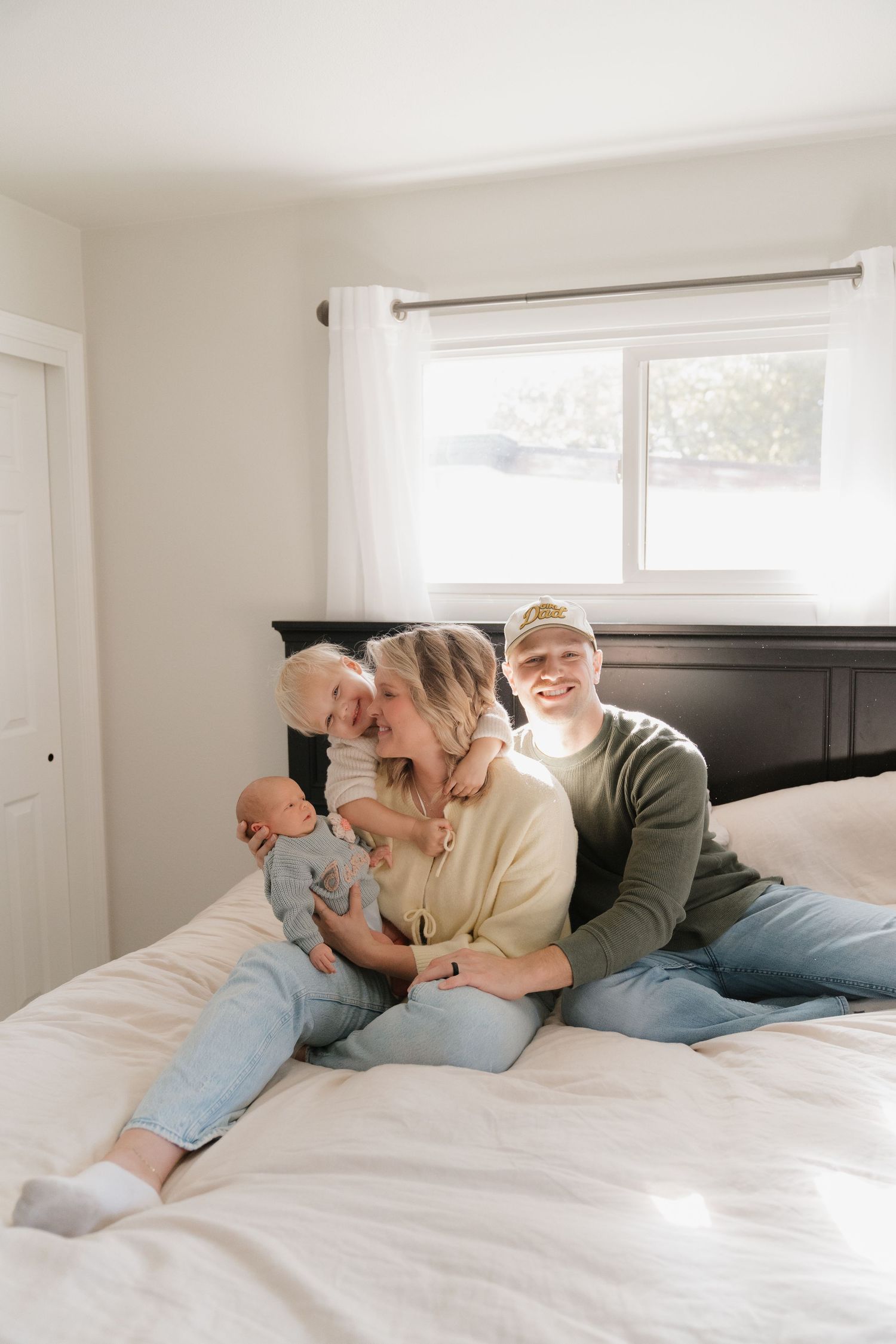 A happy couple relaxing together on a bed in a cozy bedroom setting.