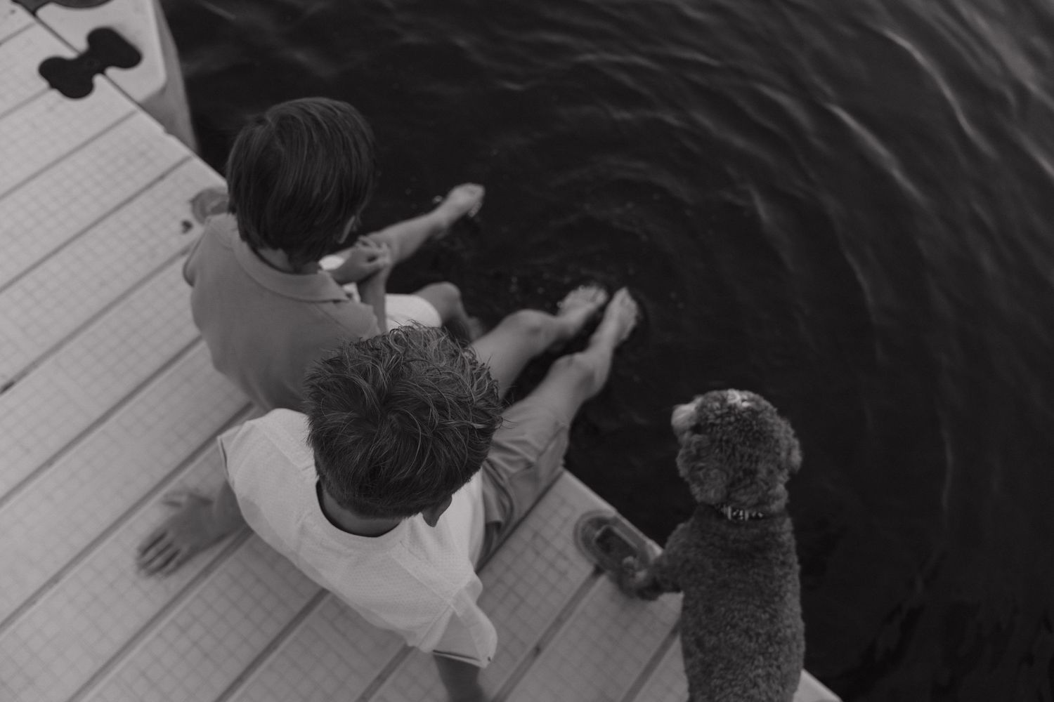 Two people are embracing in a close, intimate moment captured in black and white.