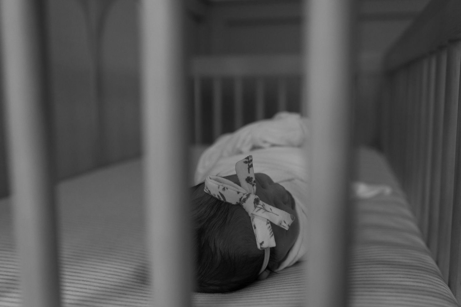 A baby's head in the crib.