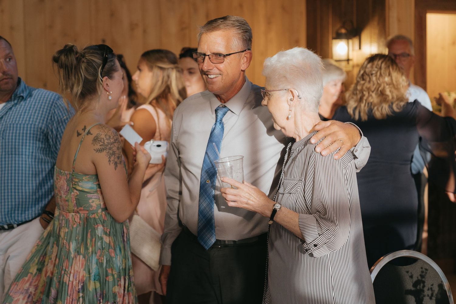 A group of people in formal attire socializing at an event.