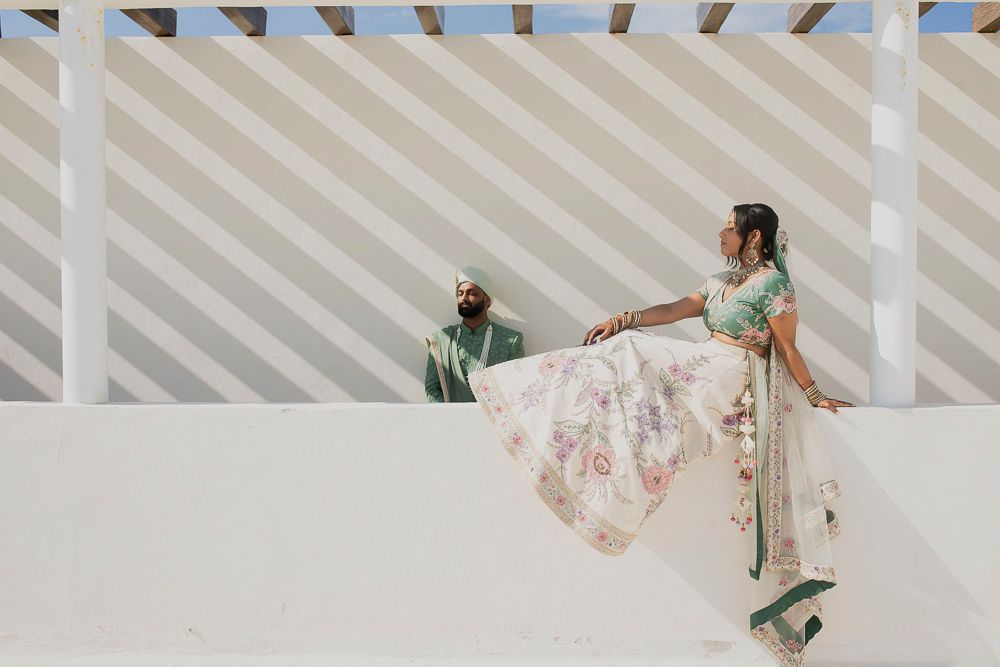 A group of dancers in floral dresses perform a synchronized dance routine on stage.