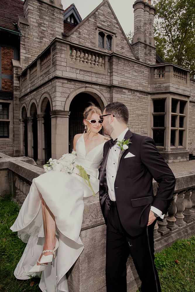 A romantic wedding photo series in front of a stone mansion featuring a couple in formal attire.