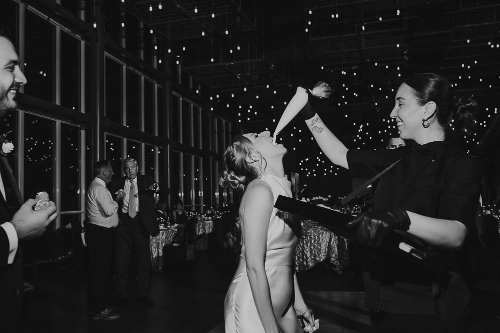 Couples dancing together at a nighttime party with twinkling lights in the background.