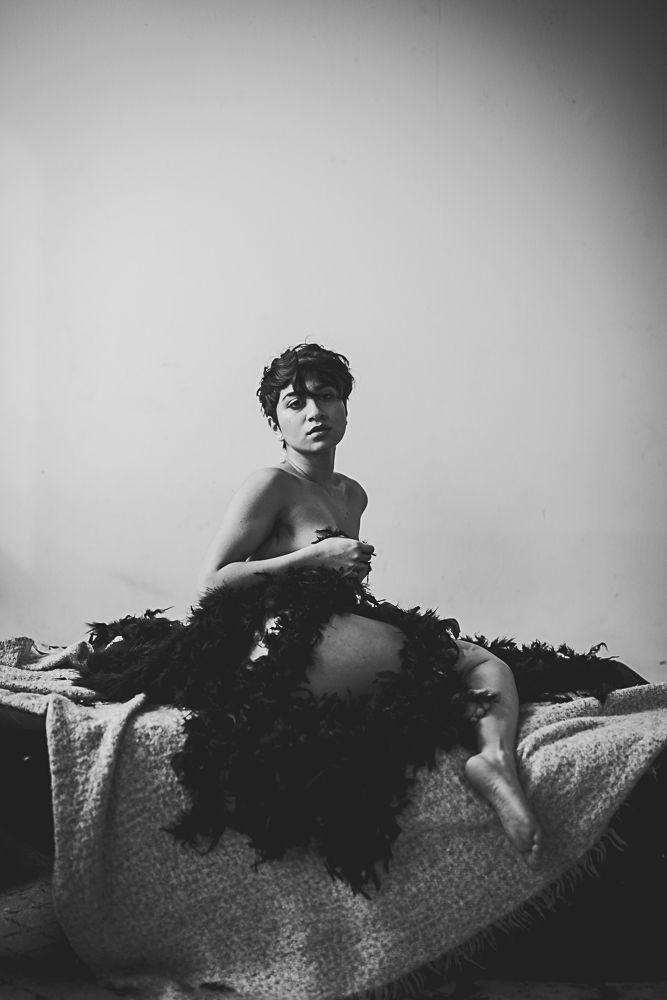 A series of black and white artistic photographs showing a reclining figure on a textured surface in dramatic lighting.