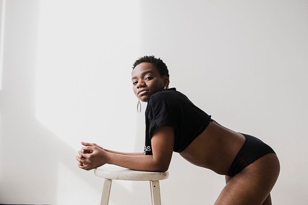 A figure in black athletic wear strikes dynamic poses against a white background in a photo series.