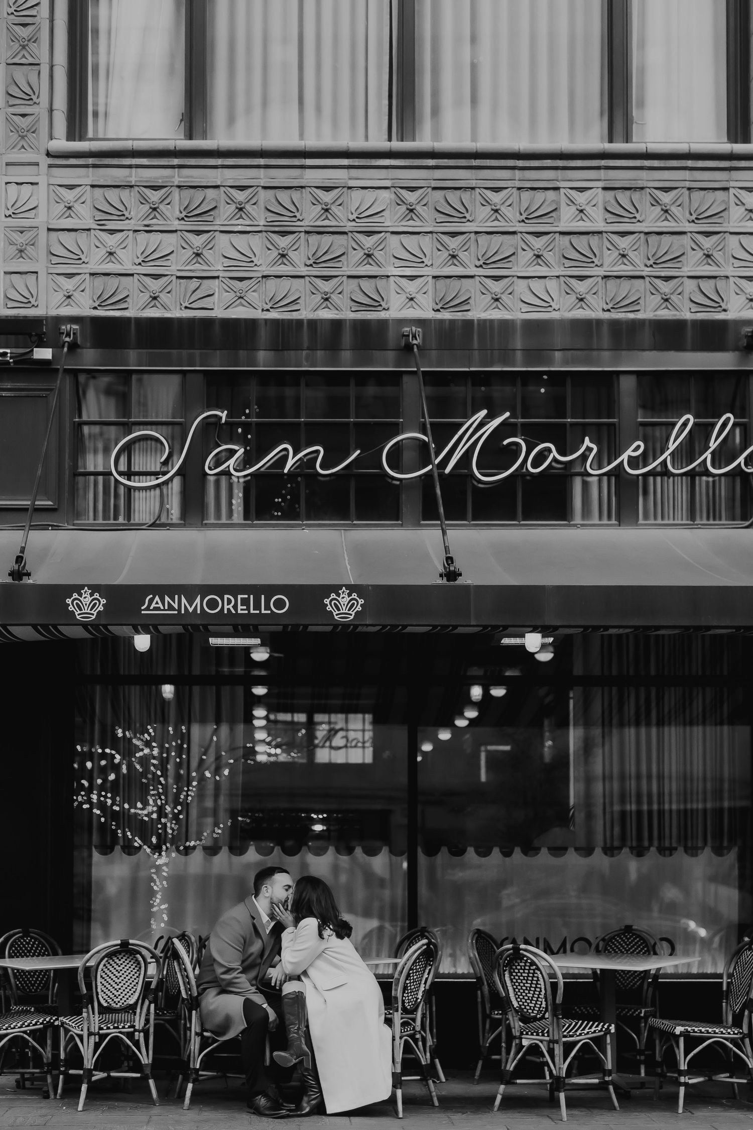 Vintage black and white photograph of San Morello storefront with classic awnings and outdoor seating.
