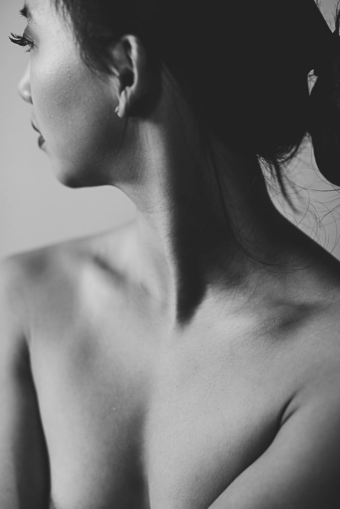 Black and white artistic portrait series showing bare shoulders and neck in dramatic lighting and angles.
