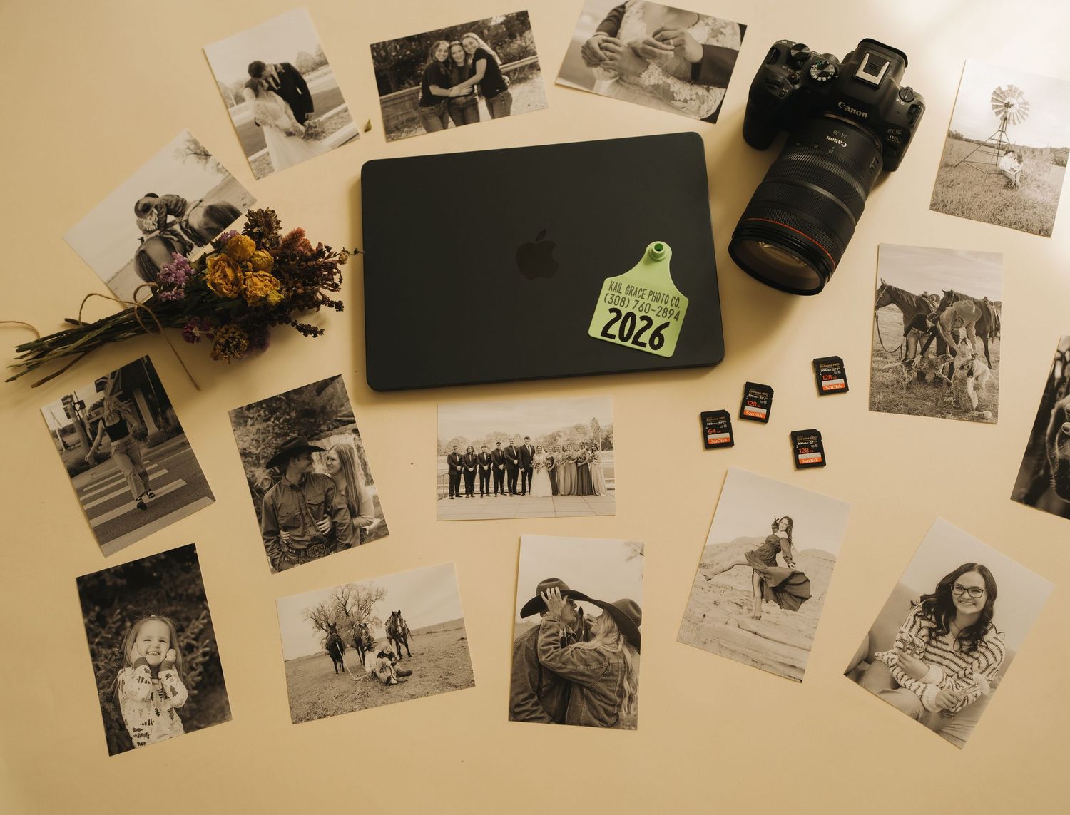 A collection of vintage black and white photographs scattered across a beige surface.