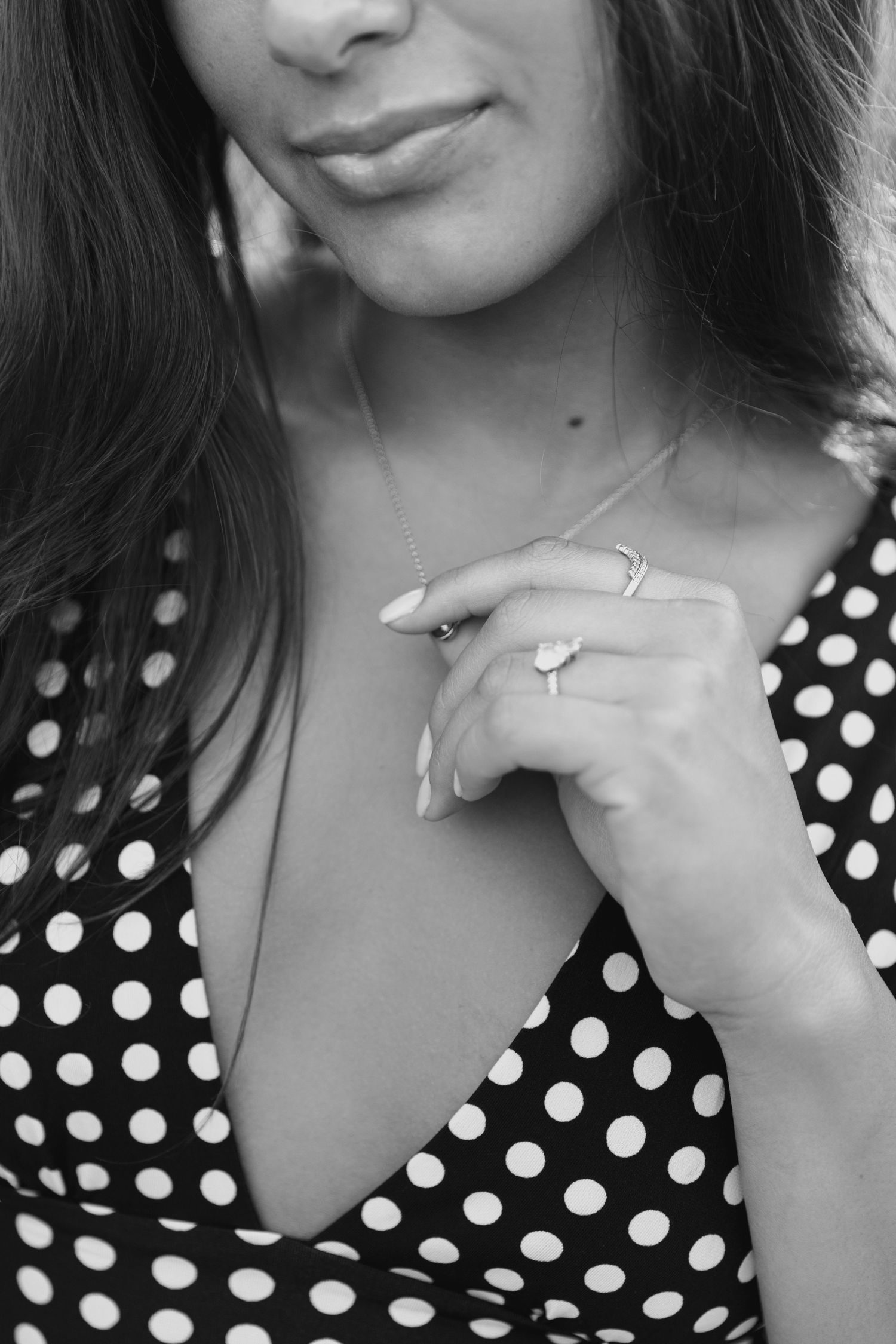Black and white portrait series showing different angles and expressions in a polka dot top.