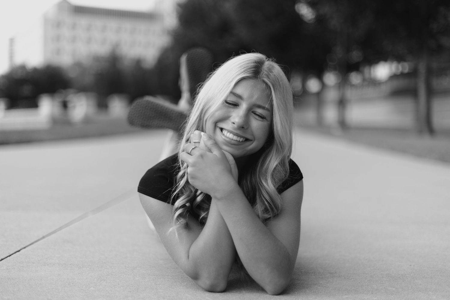 Person lying on ground in casual photo sequence outdoors.