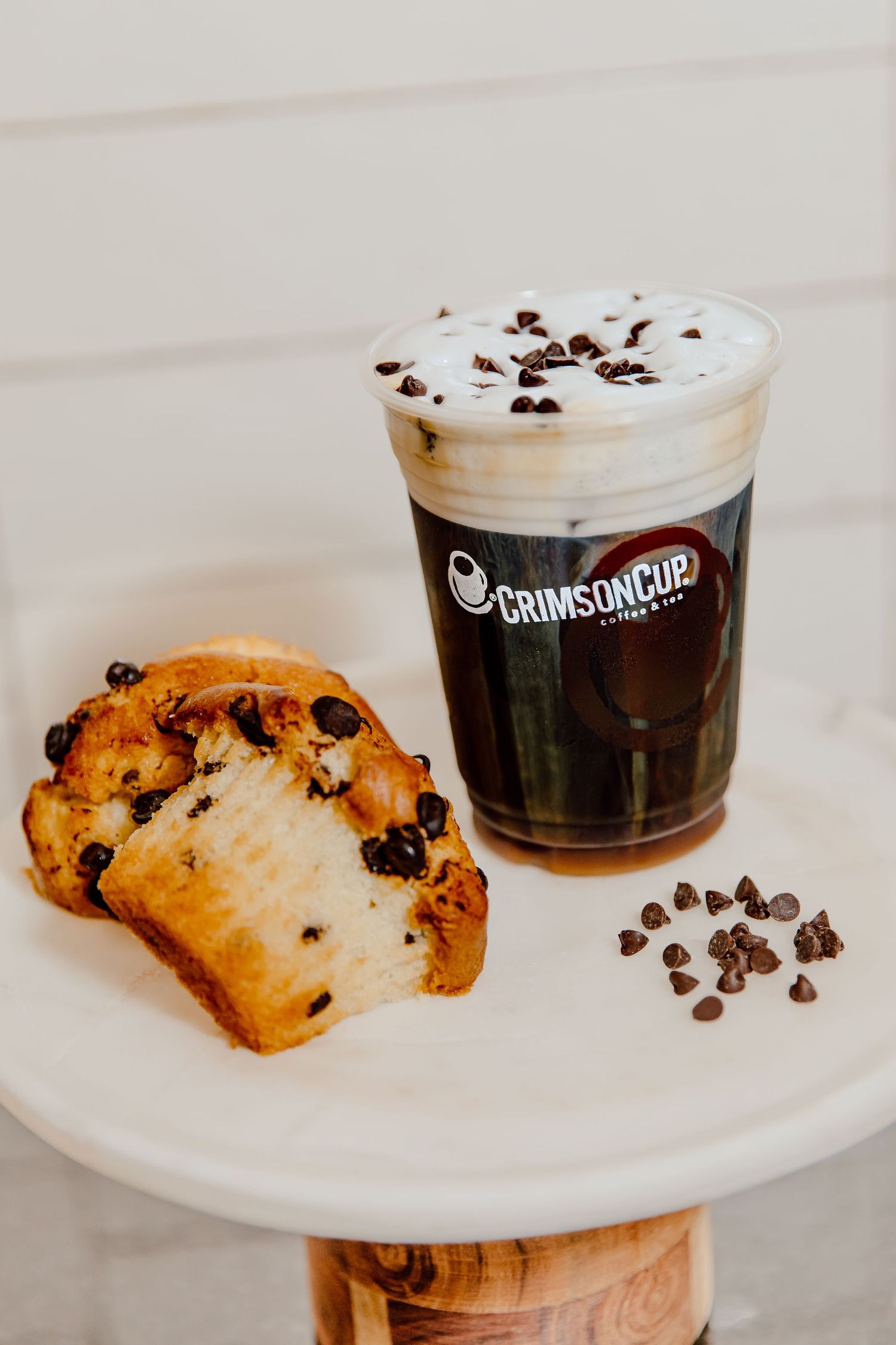 Chocolate chip cookies and coffee drinks served on white plates at Grindstone cafe.