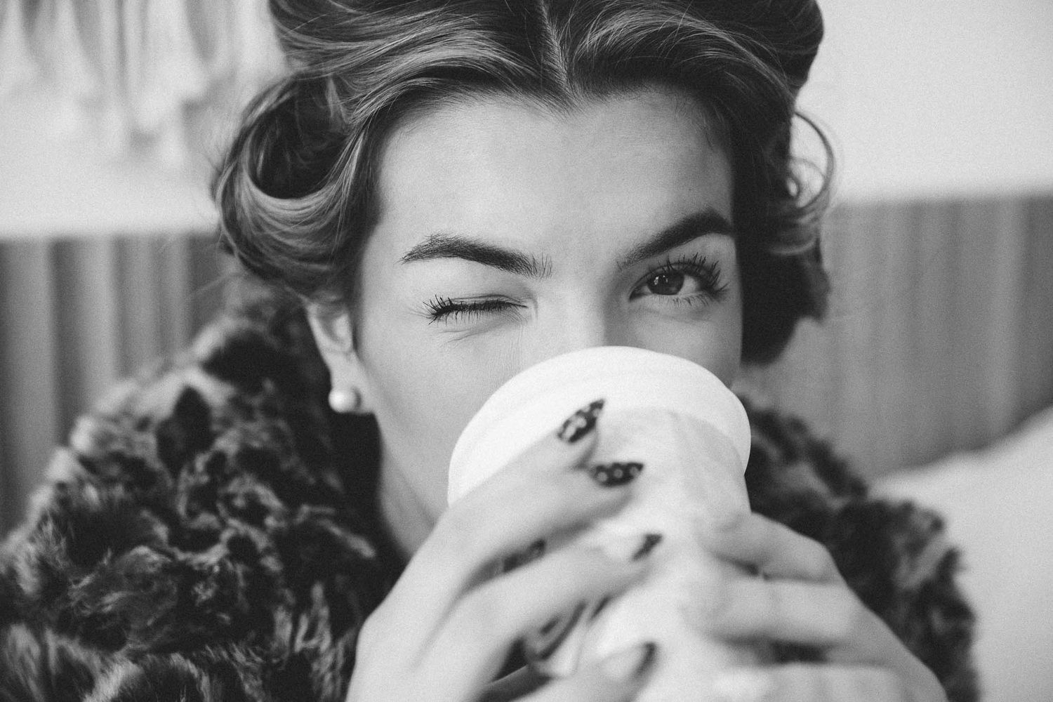 A black and white collage of people drinking from coffee cups and mugs in a retro vintage style.
