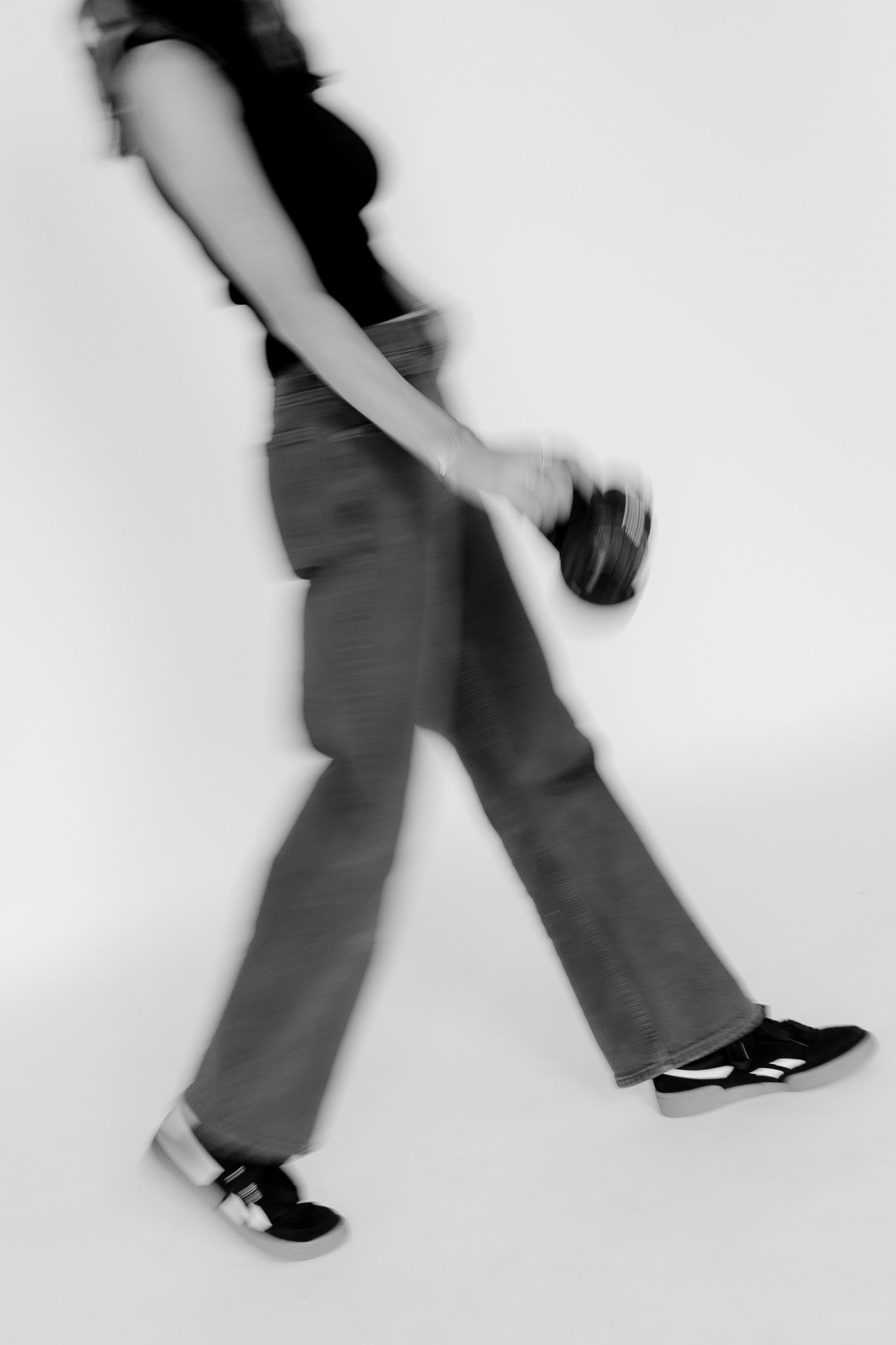 A sequence of black and white photos showing feet in motion wearing dark shoes and pants.