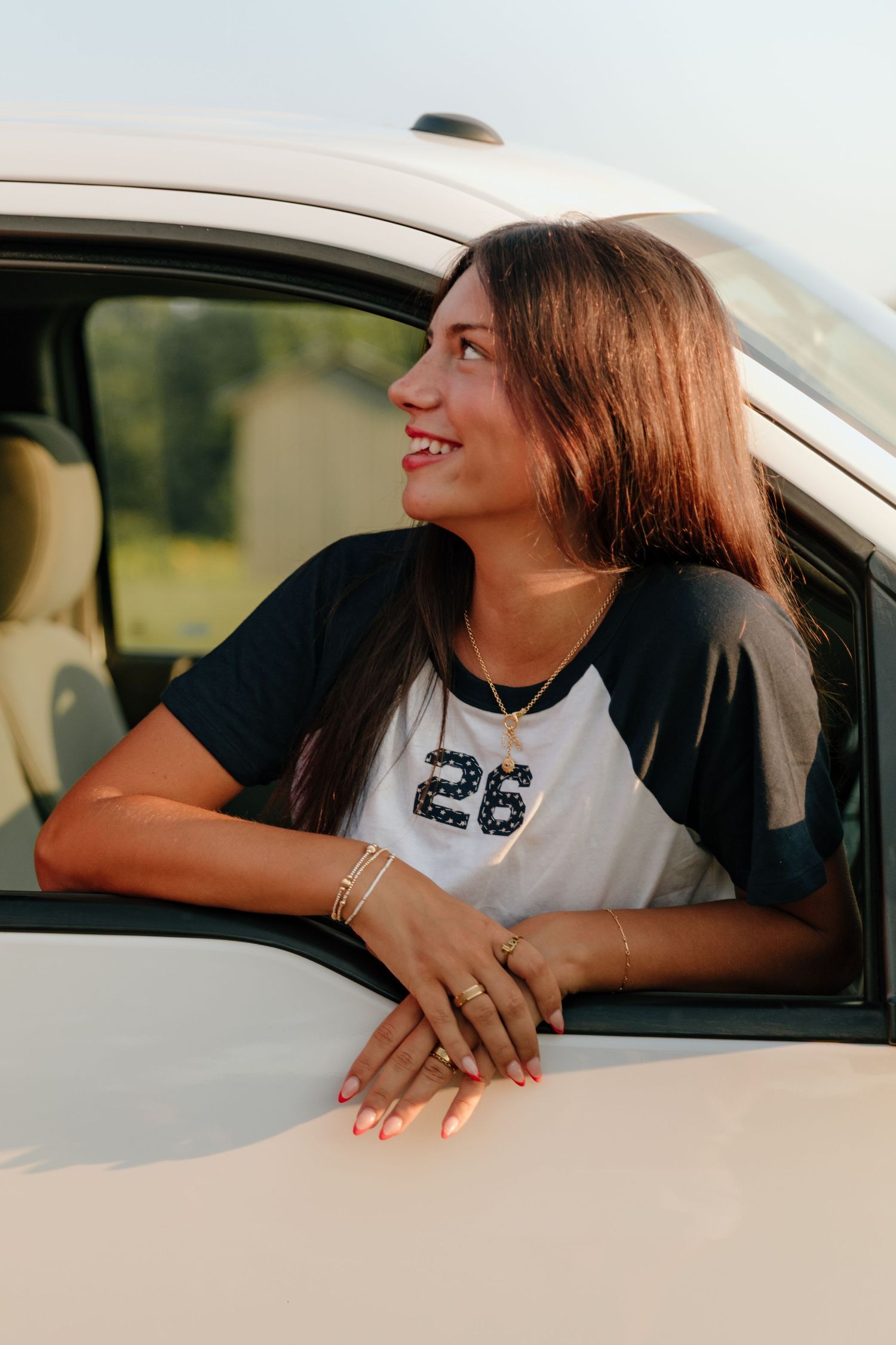 A series of candid shots showing someone smiling and looking out a car window during golden hour.