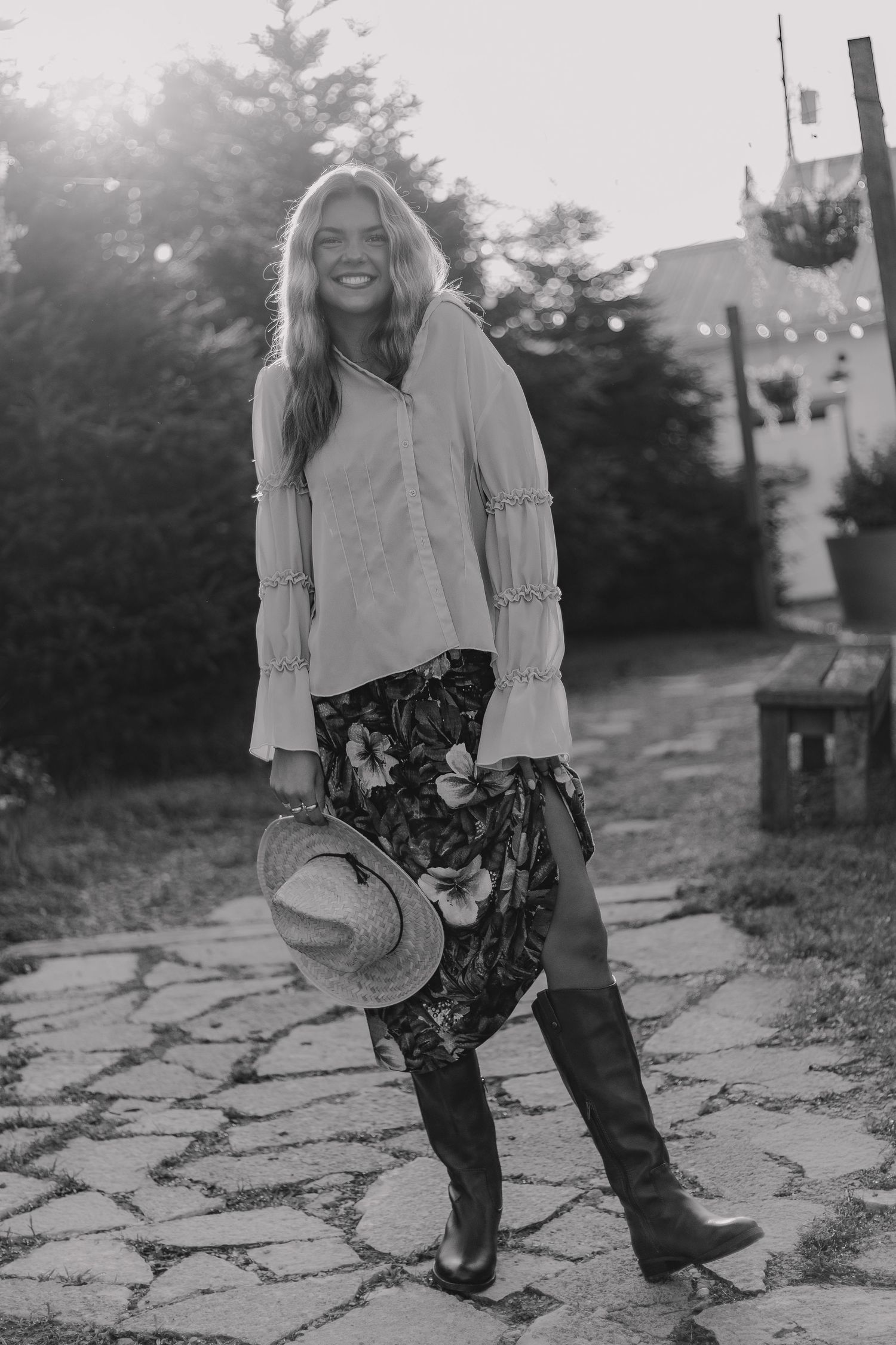 Black and white series of playful outdoor poses on stone pavement wearing patterned pants.