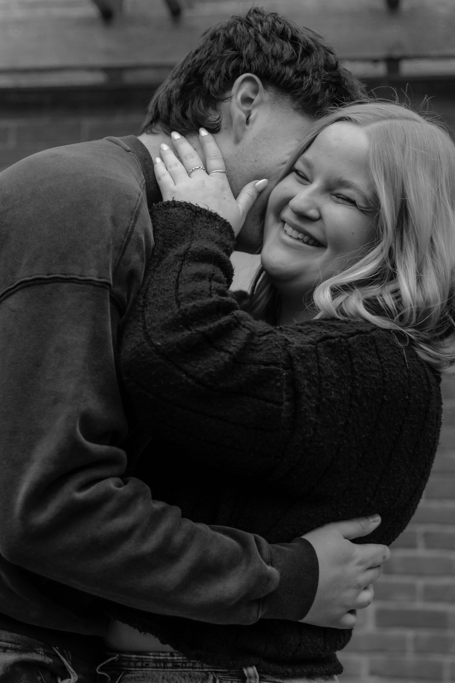 Black and white intimate portrait series showing affectionate embrace.